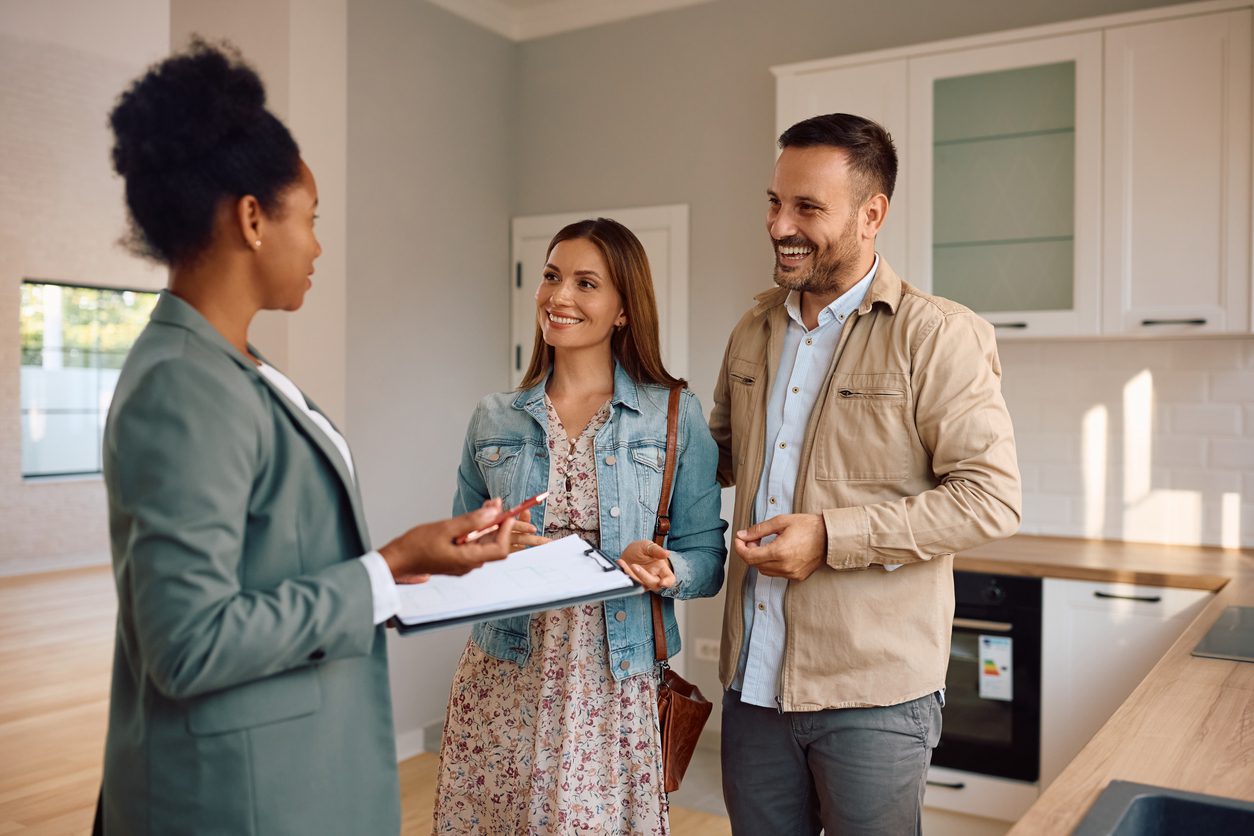 Couple discussing option for upsizing with their real estate agent